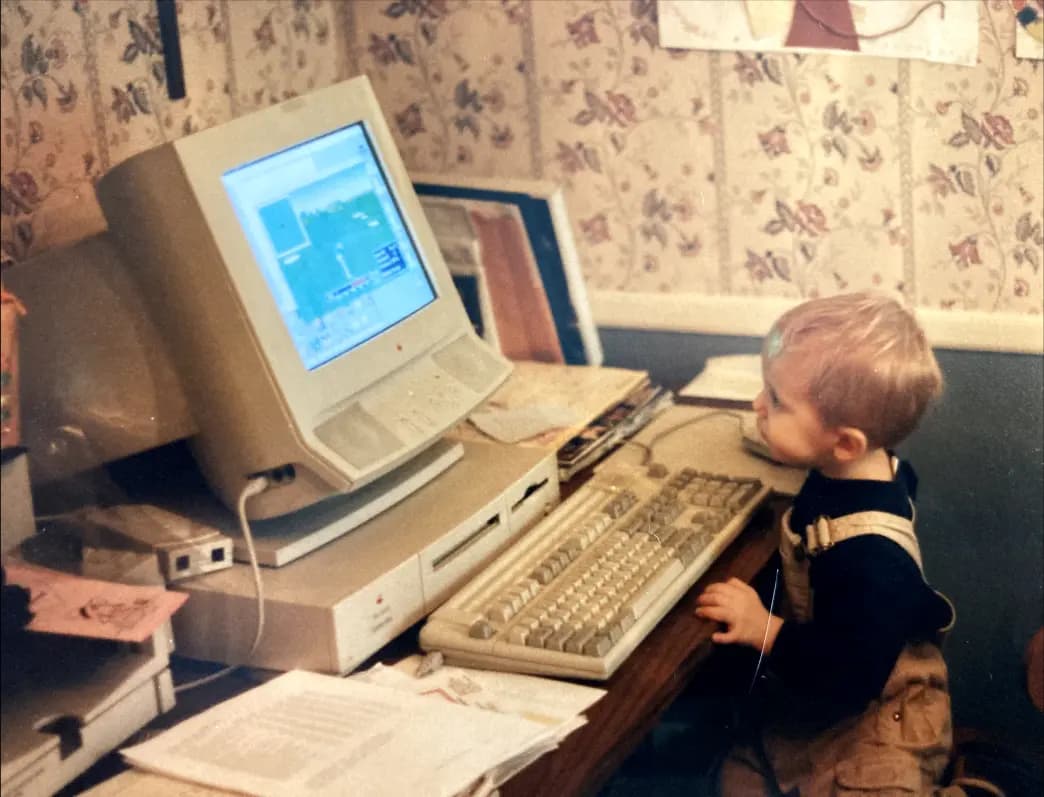 Matt on a computer playing a game when he was a child